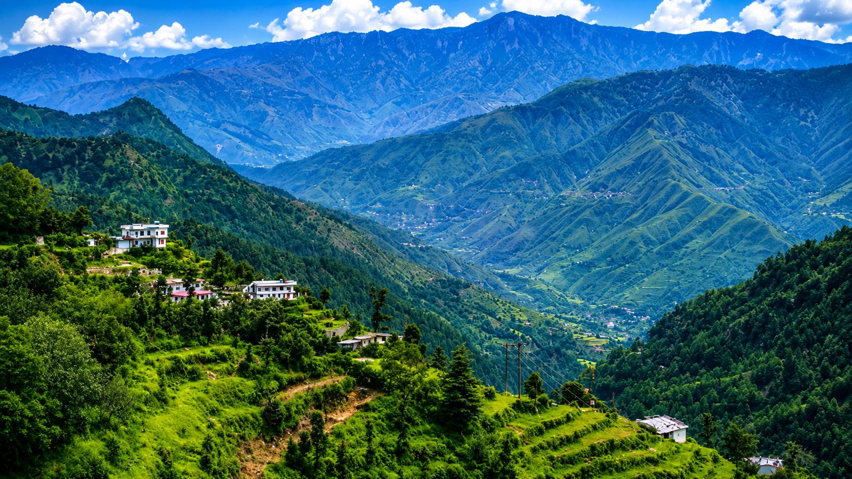 Mountain valley and hillside village near Dhanaulti, seen from a resort near Dhanaulti